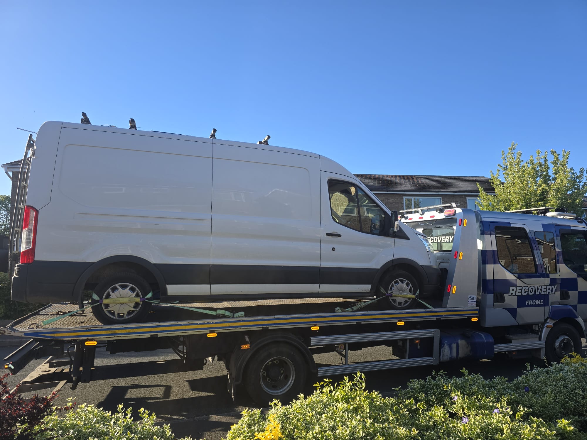 Recovery truck carrying a grey Nissan Qashqai