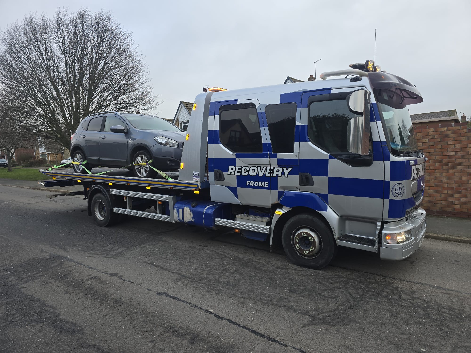 Recovery truck transporting a private hire van